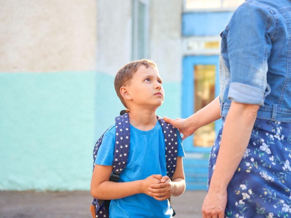 Child experiencing back-to-school anxiety before entering school