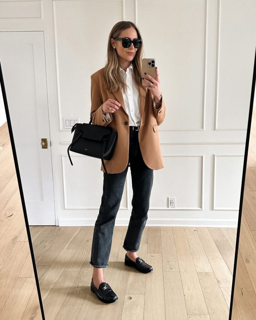 Woman wearing a relaxed blazer over a light summer top for transitional fall style