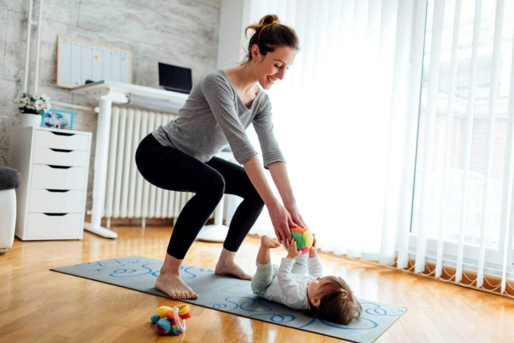 Mother examining her abdomen while starting a postpartum fitness and weight loss journey.